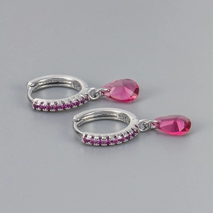 Macro detail of S925 sterling silver stamp and purple teardrop zircon earrings