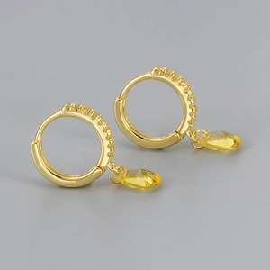 Detail of gold hoop earrings featuring pear-cut yellow zircon pendants with micro-pave crystals
