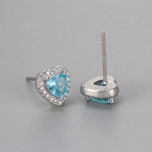 Detail of S925 silver heart stud earrings with sky blue zircon and pavé setting
