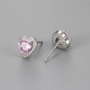 Macro detail of S925 sterling silver heart studs with pink center and zircon pavé