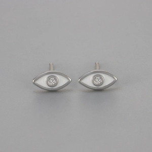 Detail view of silver evil eye stud earrings with white enamel and sparkling zircon stone