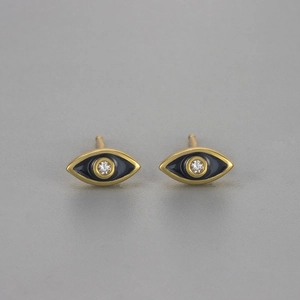 Detailed close-up of evil eye stud earrings with golden frame and black enamel finish