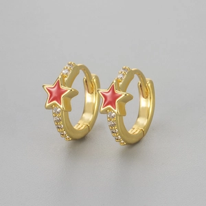 Close-up of gold hoop earrings with red enamel stars and sparkling zircon inlay