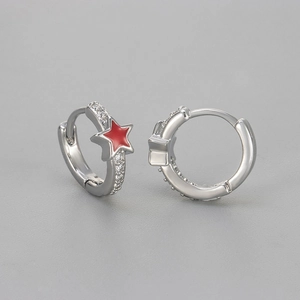 Detail of silver star hoop earrings with red enamel and pavé zircon settings
