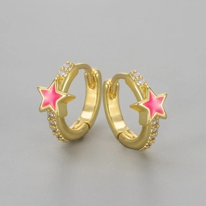 Macro shot of gold-plated hoop earrings with white zircons and pink enamel star charms