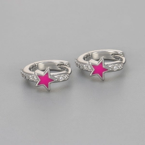 Macro detail of silver-tone hoop earring featuring a vibrant pink enamel star and sparkling zircons