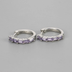 Detailed view of silver hoop earrings with five rectangular lavender zircon stones