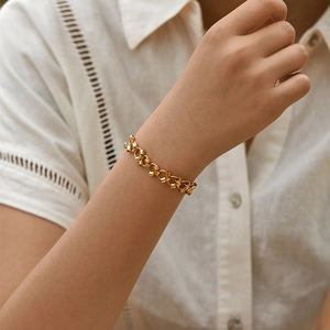 18K gold plated brass chain bracelet featuring textured round links on a model's wrist
