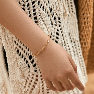 Minimalist 18K gold plated chain bracelet featuring delicate beads and textured oval charms