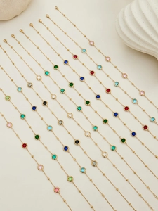 Detailed view of colorful round cut crystal gems on fine gold-plated link chains