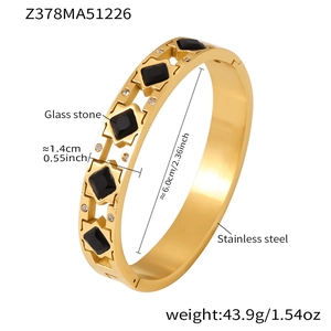 Detail of 18k gold plated stainless steel bangle with black stones and tiny zircons