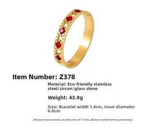 Detail view of 18k gold plated stainless steel bangle with square red zircon inlay