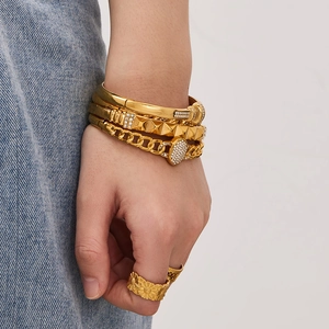 Set of four gold stainless steel bracelets and rings with rhinestones and floral details
