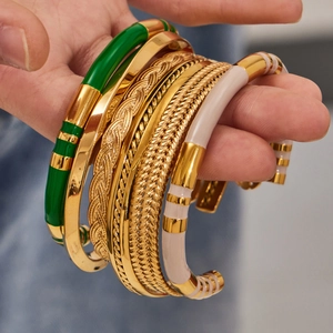 Five-piece stackable vintage gold bangles set with colorful enamel and geometric textures