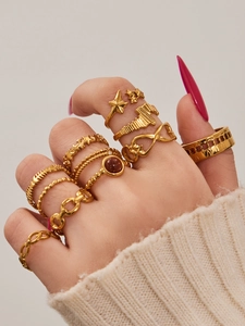 Detail of vintage 18K gold plated rings set with stars and Roman numerals