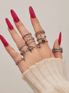 Detail of silver bohemian stacking rings set with star and infinity motifs on hand