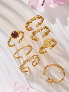 Macro detail of seven-piece vintage 18K gold plated ring set with star and stone motifs