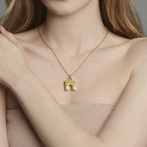 Minimalist gold-plated stainless steel arc de triomphe pendant necklace on a model