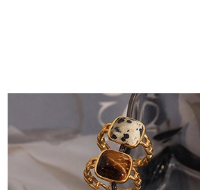 Detail of vintage 18K gold plated stainless steel rings with square natural stones