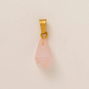 Detail of pink crystal teardrop pendant with 18K gold plated clasp on white background