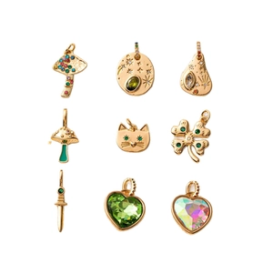 Set of nine assorted 14K gold-plated charms including heart, cat, and maple leaf designs