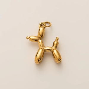 Detail shot of a 18K gold-plated balloon dog pendant with mirror-polished surface