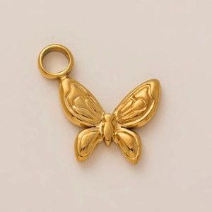 Detailed close-up of a golden butterfly pendant with textured wings and circular ring loop