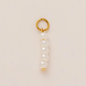 Detail of elegant pendant featuring five white pearls and a gold-plated circular ring hook