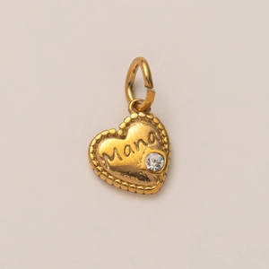 Macro detail of golden heart pendant with Mana engraving and small crystal setting