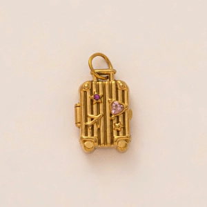 Gold suitcase pendant necklace with pink heart and airplane motifs in minimalist style
