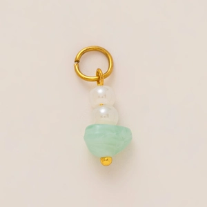 Detail of 18K gold plated skull pendant with white pearls and green resin stone