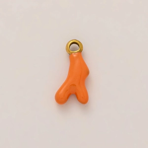 Detail of red coral branch pendant with 18K gold plated loop and smooth enamel finish