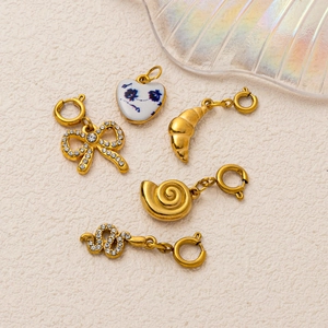 5-piece 18K gold plated charm set featuring bow, heart, croissant, snail, and snake shapes