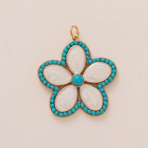 Detailed macro view of the gold flower pendant with white pearly petals and blue beads