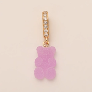 Detail of pink gummy bear pendant with sugar texture and gold pavé zircon ring