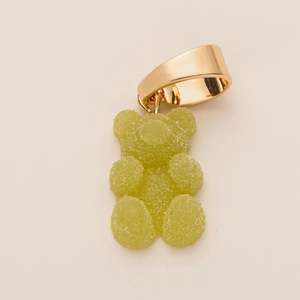Macro detail of gummy bear boot charm featuring sugar texture and gold plating