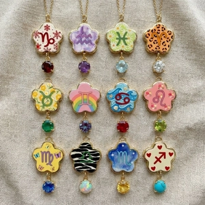 Lot de 12 pendentifs zodiaque en or 18K avec émail coloré et pierres précieuses