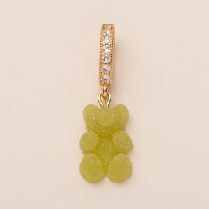 Close-up of green sugar-coated gummy bear pendant with zircon inlaid gold ring