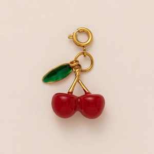 Exquisite red cherry pendant with glossy enamel finish and a green leaf detail on golden hook