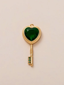 Detail van de 18K vergulde vintage sleutelhanger met groene hartsteen en kleine kristallen
