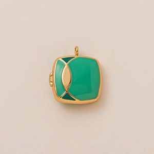 Macro shot of 18K gold-plated box pendant with green enamel and side hinge details