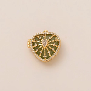 Macro detail of heart-shaped locket pendant with green enamel and sparkling rhinestones