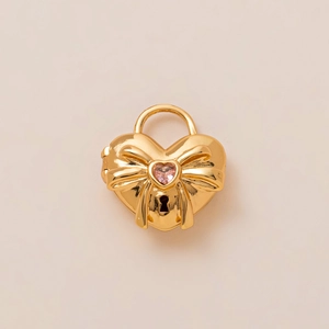 Detail of 18K gold-plated heart padlock pendant with pink crystal and bow relief