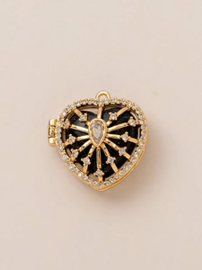 Detail of 18K gold-plated heart locket with blue starstone and zircon stones