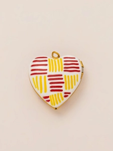 Detailed top view of a gold-plated heart pendant with red and yellow woven enamel patterns