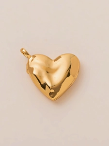 Detailed close-up of a polished heart-shaped locket pendant with mirror gold finish