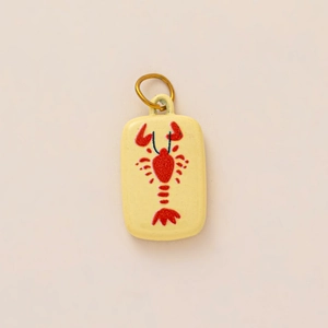 Close-up of a rectangular yellow ceramic pendant featuring a hand-painted red lobster design