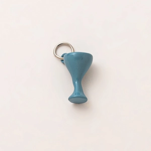 Detail of blue ceramic wine glass pendant with silver ring and polished finish