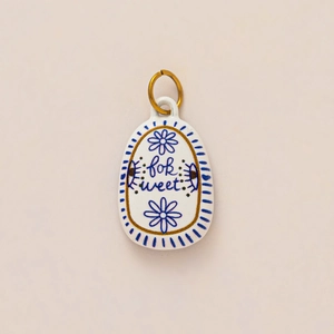 Hand-painted ceramic oval charm with blue floral pattern and gold 'for sweet' text