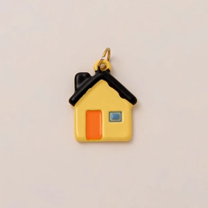 Detailed close-up of 18K gold-plated house charm with colorful enamel windows and doors